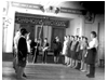прибл.1963г. Пионерский сбор в старом здании АСШ, в глубине сцены транспорант: Нынешнее поколени...будет жить при коммунизме, справа в верхн. углу - портрет Хрущева.